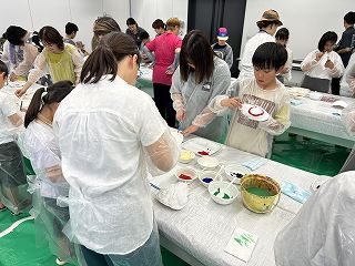 タカアシガニのお面に色を塗る様子